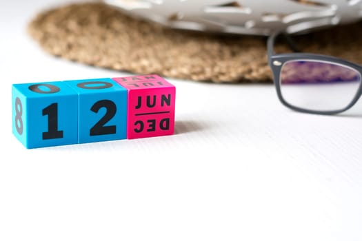 modern perpetual calendar composed of colored cubes and set at the date of June 12