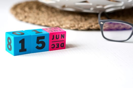 modern perpetual calendar composed of colored cubes and set at the date of June 15