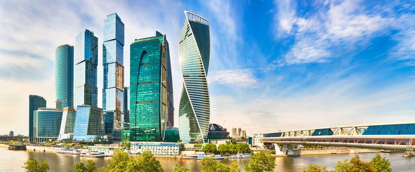 Moscow City skyline . Moscow International Business Centre at day time with Moskva river in foreground . Panorama