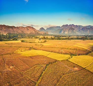 Aerial view of the fields and mountain. Beautiful landscape. Vang Vieng. Laos.