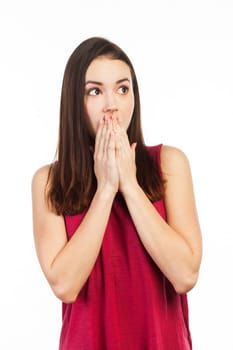 Young woman astonished and holding her hands in front of her mouth, isolated on white