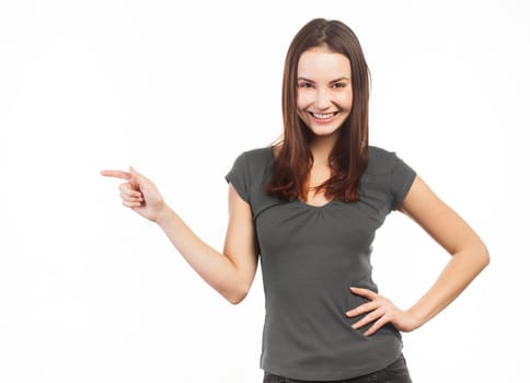 Cheerful woman pointing at copy space, isolated on white