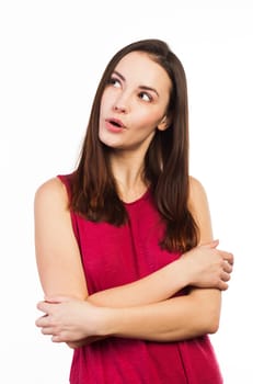 Pretty young woman looking up at copy space, on white background