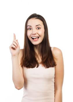 Portrait of an attractive woman pointing at copy space, isolated on white