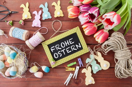 Colorful Easter decoration and tulips rustic background made of wood