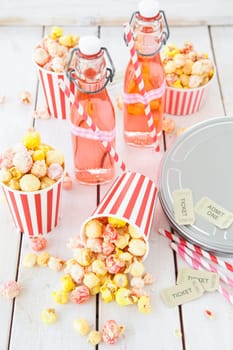 Colorful popcorn in striped cups and lemonade in small faschen
