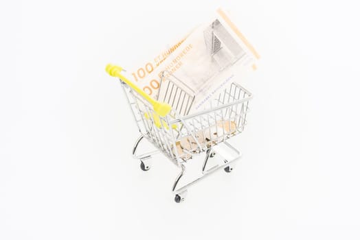 Miniature shopping cart with Danish Krone banknotes and coins