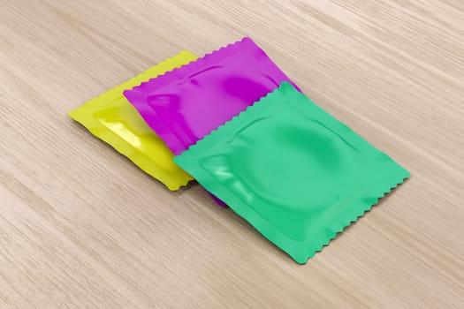 Three different condoms on wooden table