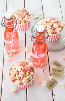 Colorful popcorn in striped cups and lemonade in small faschen