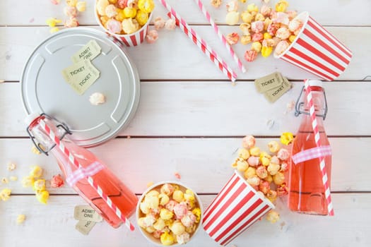 Colorful popcorn in striped cups and lemonade in small faschen