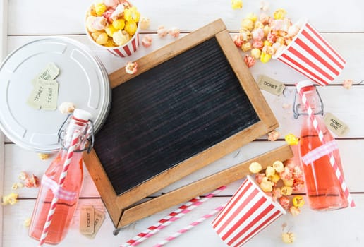 Colorful popcorn in striped cups and lemonade in small faschen