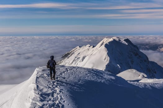 climbing on mountain in winter. Piatra Craiului Mountains, Romania