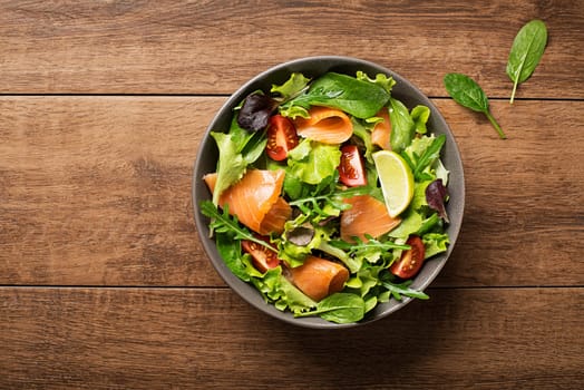 Fresh green salad with smoked salmon and cherry tomatoes