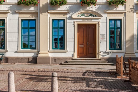 Esens,Germany - October 05,2016: Frontal view of the entrance door of the town hall in Esens with parts window front on the ground floor in classicist architectural style.