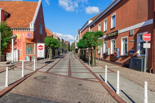 Esens,Germany - October 05,2016: View into the deserted Westerstraße in the city of Esens with typical North German buildings in good autumn weather.