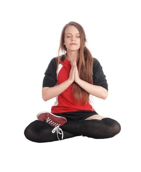 A young slim woman sitting in a joga pose with her eyes closed and.meditating and her legs crossed, isolated for white background.