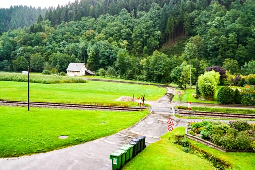 Courtyard entrance with level crossing in rainy weather in the Black Forest