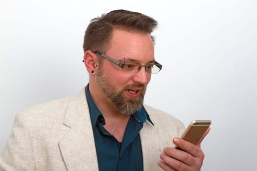 Young man behaves on his mobile phone with a bright background