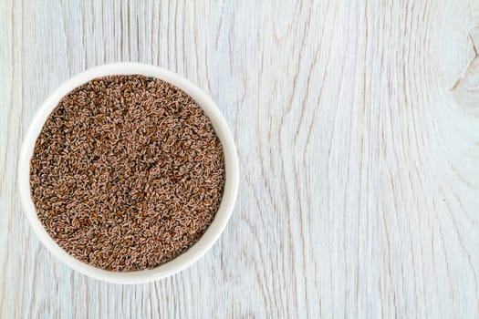 Top view of psyllium seeds in a white porcelain bowl