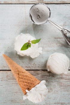 Top view coconut ice cream wafer cone on white rustic wooden background.