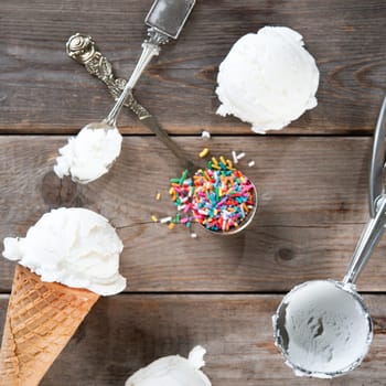Top view yoghurt ice cream wafer cone on rustic wooden background.