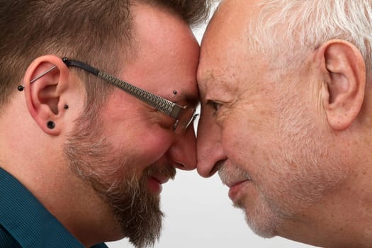 Happy gay couple with a large age difference on a bright background