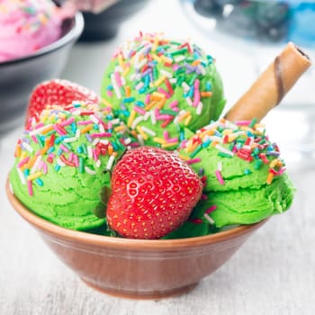 Lime ice cream in bowl on wooden background.