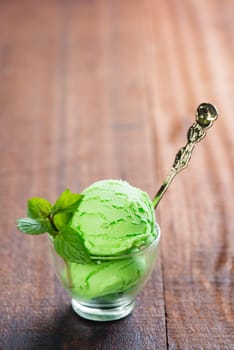 Matcha ice cream in cup on dining table.