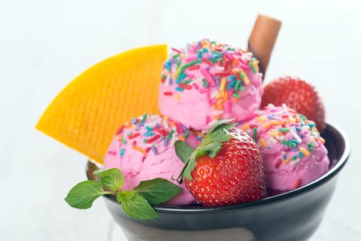 Close up pink ice cream in bowl with strawberry fruits and waffle