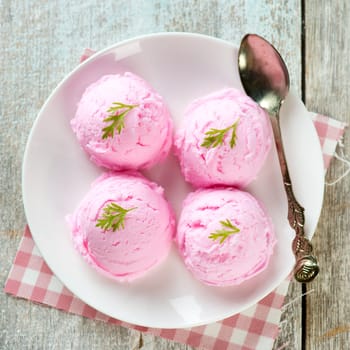 Top view strawberry ice cream plate on wooden background.