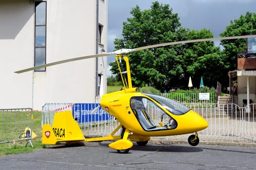 Gyroplane parked at the foot of the control tower of the aerodrome