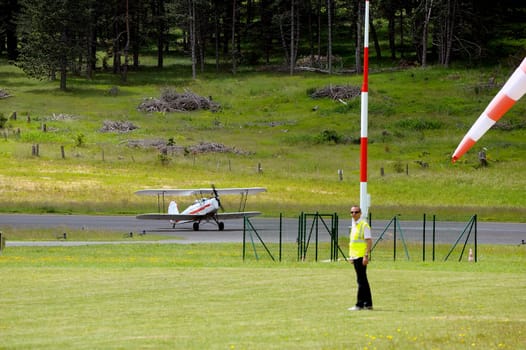 landing a biplane rolling on the Mende airfield in the French department of Gard to go to park in the place reserved for him