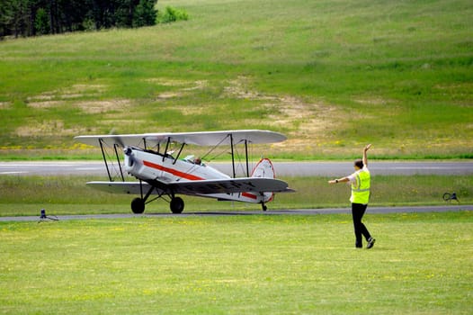 landing a biplane rolling on the Mende airfield in the French department of Gard to go to park in the place reserved for him