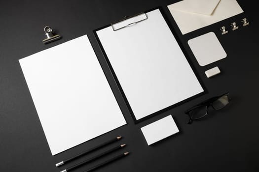 Blank stationery set on black paper background. Template for branding identity.