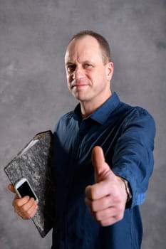 young businessman with folder, phone and thumb up