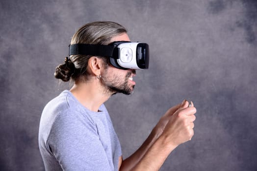 young man with virtual reality glasses playing game