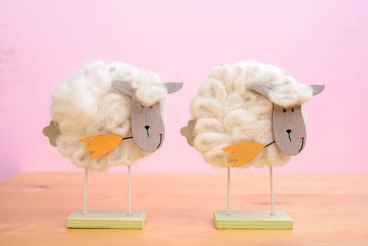 funny sheep with flower in front of pink background