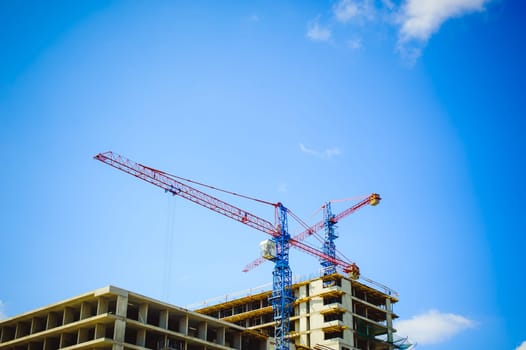 pair of cranes at the construction site