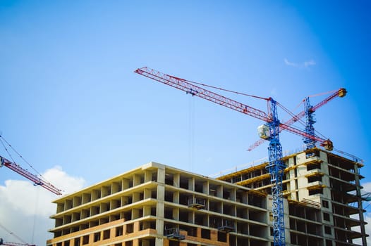 pair of cranes at the construction site
