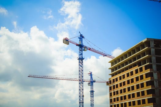 pair of cranes at the construction site