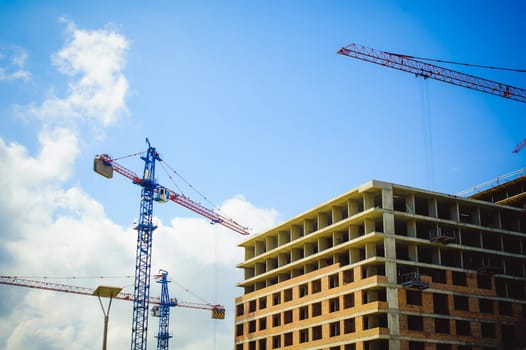 pair of cranes at the construction site