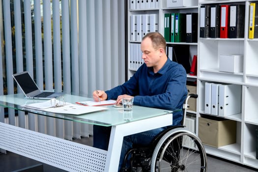 disabled businessman in wheelchair working in the office
