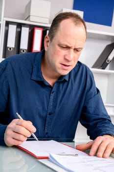 young business man at his desk write