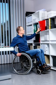 disabled businessman in wheelchair working in the office