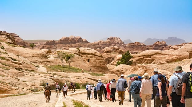 PETRA, JORDAN - APRIL 25, 2016: Tourists travellers visiting Petra in Jordan during spring vacation. Petra, Jordan - April 25, 2016