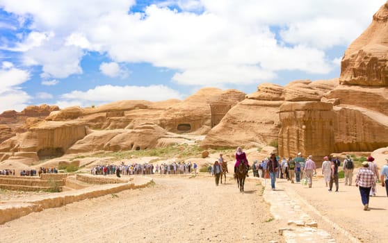 PETRA, JORDAN - APRIL 25, 2016: Tourists travellers visiting Petra in Jordan during spring vacation. Petra, Jordan - April 25, 2016