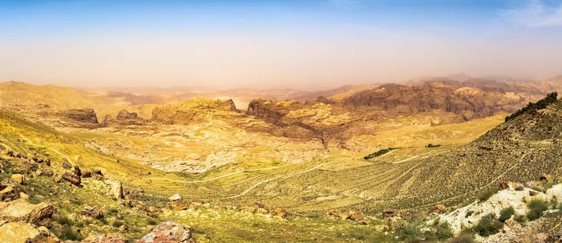Travel to Middle East country Kingdom of Jordan - blue sky over mountain around Wadi Araba (Arabah, Arava, Aravah) area near Petra town in sunny spring day.