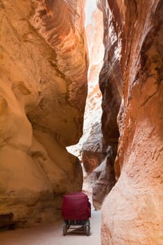 The Siq - stone gallery in a horse carriage to the hidden city of Petra, Jordan. UNESCO World Heritage Site