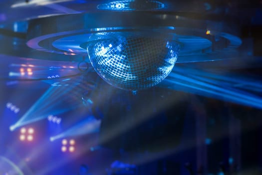 Disco ball with bright rays, night party or concert background