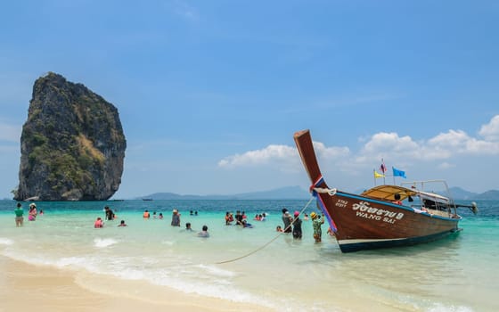 KRABI, THAILAND - APRIL 12, 2016 : Poda Island, white sandy beach with turquoise andaman sea water and long-tailed boat taxi in Krabi province, Thailand.